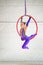 Girl aerial gymnast on a circle doing acrobatic elements