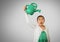 Girl against grey background with Green watering jug