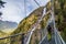 Girl alone on stairs beside Stuibenfall waterfall, Umhausen, Austria