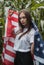 The girl with the American flag outdoors, the location is a cornfield,