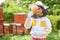 Girl analyzing organic beeswax at apiary garden