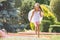 Girl with angel wings running around in the rain in the garden