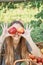 Girl with Apple in the Apple Orchard. Beautiful Girl Eating Organic Apple in the Orchard. Harvest Concept. Garden, teenager eating