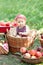 Girl with Apple in the Apple Orchard. Beautiful Girl Eating Organic Apple in the Orchard. Harvest Concept. Garden, Toddler eating