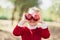 Girl with Apple holding in front of her face in Orchard. Harvest Concept