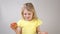 Girl with an Apple. Little girl eating an Apple Girl in a yellow bright dress on a white background.