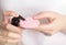 A girl applies a cleansing tonic to a silicone facial brush, close-up. Hygiene and skin care concept, treatment