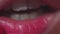 Girl apply red lipstick stick on lips close up