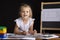 Girl-architect sitting behind a Desk and looks in a frame