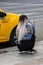 Girl asking taxi driver if available for a ride. Taxi car parked at the taxi station in the capital city of Bucharest, Romania,