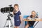 Girl astronomer looks at the sky, the other girl sitting happily at the table