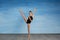 Girl athlete doing exercise gymnastics, looking at the camera