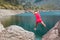 Girl athlete jumps between its stones in the mountains