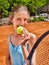Girl athlete with racket and ball on brown