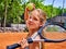 Girl athlete with racket and ball on tennis