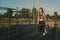 A girl of an athletic physique is engaged on the uneven bars on a street playground