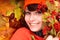 Girl in autumn orange hat on leaf group.