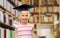 Girl in bachelor hat or mortarboard at library