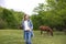 Girl on the background of grazing horses