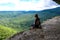 A girl on the background of the landscape of the Caucasus Mountains - The Eagle Rocks Mountain shelf, Mezmai.