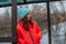 Girl on the background of winter lake or river. Girl in winter clothes on a background of the river