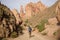 A girl with a backpack goes along the bottom of the Charyn Canyon.
