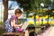 Girl with a backpack sitting on a bench and reading a book near the school. Back to school, lesson schedule, a diary with grades.