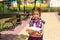 Girl with a backpack and a stack of books near the school. Back to school, the child is tired, heavy textbooks. Education, primary