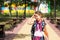 Girl with a backpack and a stack of books near the school. Back to school, the child is tired, heavy textbooks. Education, primary