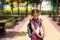 Girl with a backpack and a stack of books near the school. Back to school, the child is tired, heavy textbooks. Education, primary