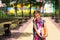 Girl with a backpack and a stack of books near the school. Back to school, the child is tired, heavy textbooks. Education, primary