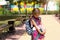 Girl with a backpack and a stack of books near the school. Back to school, the child is tired, heavy textbooks. Education, primary