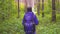 Girl with backpack walk in the woods, slow mo