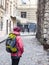 Girl with a backpack walking around the old town.