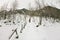 Girl backpacker walking on a bridge over a frozen river in the w