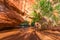 Girl Backpacker walking under Natural Bridge Arch Coyote Gulch