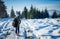 Girl backpacker walking in winter mountain forest