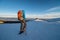 Girl backpacking towards Wolfsberger hut with snowshoes on a sunny day in winter in sunset, Saualpe alpine range, Austria