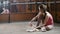 Girl balerina dancer putting on her ballet shoes