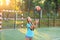 Girl with a ball in his hands on the football field.