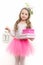 Girl ballerina in pink skirt tutu hold lantern and boxes