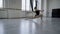 Girl ballerina sits in a twine in a bright ballet hall. hand dance 4K