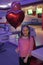 Girl with balloons celebrate birthday in bowling club. Birthday party at bowling. Ideas how to celebrate birthday for