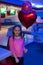 Girl with balloons celebrate birthday in bowling club. Birthday party at bowling. Ideas how to celebrate birthday for