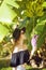 Girl with banana tree in Tropic