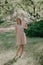 Girl barefoot in a summer garden on the grass