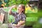 Girl with a basket of fruit in the garden. Beautiful little farmer girl holding organic fruits. The concept of harvest. Garden, To