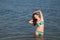 Girl in bathing suit stands in the water