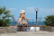 Girl in bathing suit under open sky sits in chair