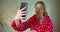 Girl in a bathrobe holding a smartphone and taking a home selfie